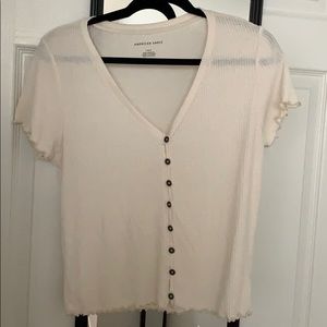 Cream t shirt with buttons down the middle
